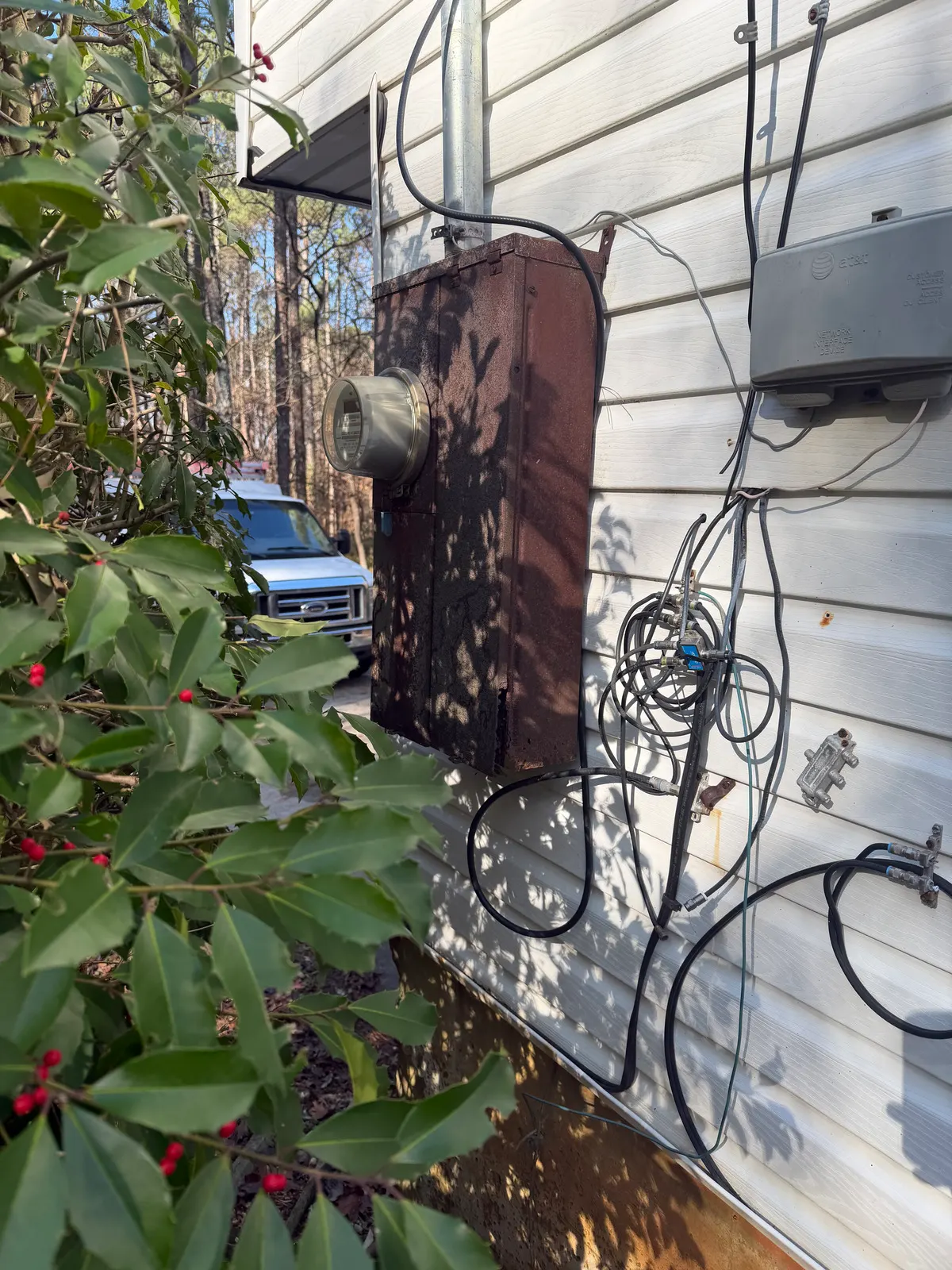 Existing electric meter and weather head in Kennesaw before the service upgrade